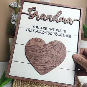 Wooden puzzle heart plaque detail showing engraved Grandma text and warm home decor style.