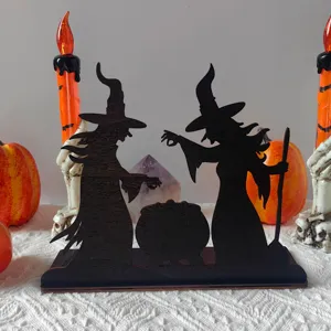 Detailed shot of Halloween wooden witch and cauldron desktop decor with ambient lighting effect.
