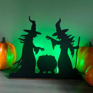 Halloween wooden LED desktop decoration detail showing witch silhouette and glowing green light.