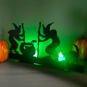 Halloween wooden witch silhouette detail shot, glowing green LED desktop decor prop.