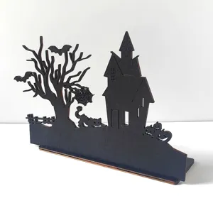 Detailed close-up of the black wooden Halloween haunted house tabletop decoration and spooky tree.