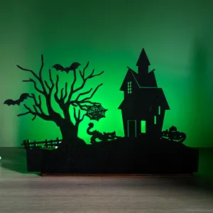 Detail view of wooden Halloween LED lighted silhouette decor with haunted house and bats.