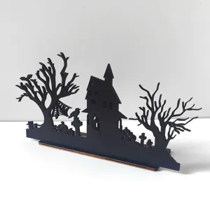 Halloween wooden laser cut haunted house decoration detail shot, black silhouette festival table decor.