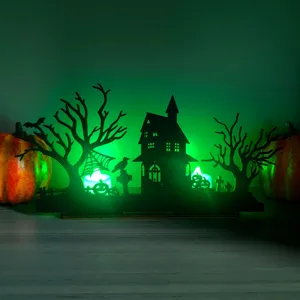 Halloween wooden lighted table centerpiece detail, spooky haunted house silhouette decor.