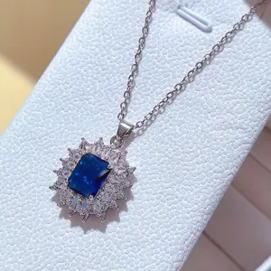 Dettaglio in primo piano di una collana con gemma blu scintillante e contorno zirconi.