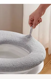 Primer plano detallado de la funda de asiento de inodoro de felpa gruesa con tirador.