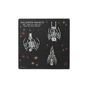 Detailed shot of Halloween wooden fridge magnet board with bat skeleton shapes and stars.