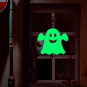Luminous ghost hanging decoration detail view showing glowing effect in dark Halloween setup.