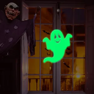 Close-up view of glowing Halloween ghost and bat wall sticker showing luminous effect.