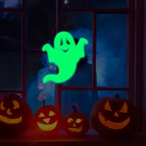 Halloween glowing ghost window hanging decoration with carved pumpkins for holiday party decor.