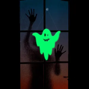 Close-up view of a glowing green ghost Halloween hanging decoration creating spooky lighting scenes.
