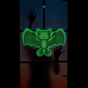 Detailed view of glowing green Halloween bat hanging decoration, perfect for spooky window display.