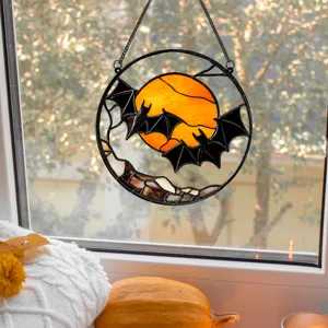 Detailed view of Halloween stained glass bat moon hanging decoration pendant on window sill.