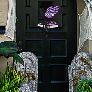 Halloween acrylic crow on book hanging decoration detail showing texture and purple design.
