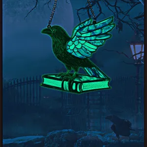 Closeup of the glowing Halloween raven and book acrylic hanging decoration in night scene.