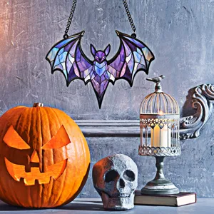 Detailed view of stained glass acrylic bat hanging ornament in Halloween theme scene.