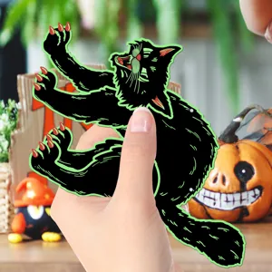 Close-up view of a black cat Halloween hanging decoration cutout with vibrant green outline details.