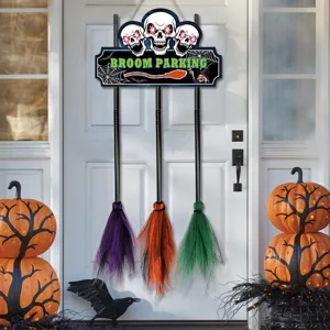Halloween wooden door sign detail, spooky skull pattern with three hanging colorful witch brooms.