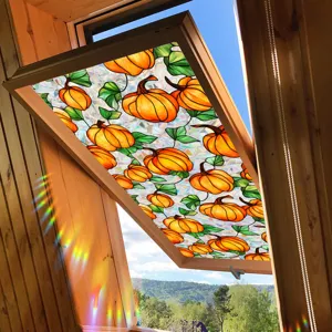 Halloween window sticker detail showing stained glass pumpkin design and vibrant light refraction.