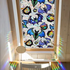 Halloween stained glass window film detail, colorful bat and cauldron pattern effect.