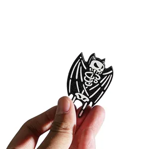 Wooden Halloween skeleton bat fridge magnet, spooky home kitchen decoration detail view.
