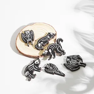 Wooden skeleton cat bat fridge magnets detail shot, spooky Halloween kitchen holiday decor items.