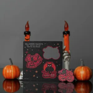 Detailed close-up view of wooden Halloween fridge magnets, showing laser cut ghost designs.