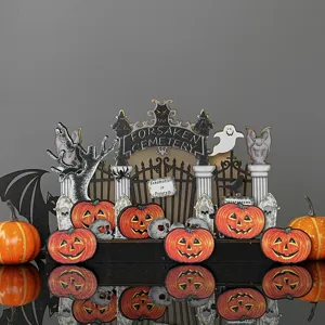Halloween wooden cemetery table decoration set with pumpkins, skulls, ghosts, and spooky signs.