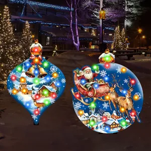Close-up detail of glowing Christmas yard stakes featuring illuminated Santa sleigh and village.