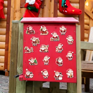 Detailed view of cute Christmas Santa Claus and snowman fridge magnets displayed on a red mailbox.