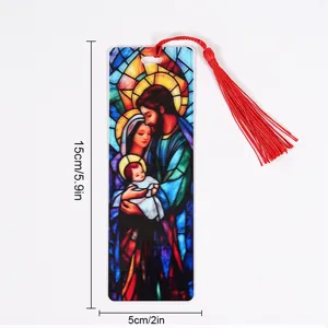 Clear acrylic bookmark detail showing stained glass religious design and attached red tassel.