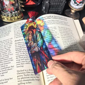 Detailed shot of transparent acrylic bookmark with stained glass holy family art design.