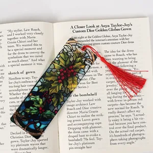Christmas acrylic bookmark with red tassel, clear stained glass holly design for readers.
