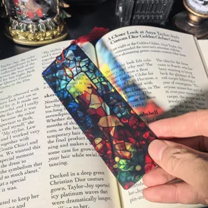 Transparent acrylic stained glass bookmark with red tassel, beautiful book reading accessory.