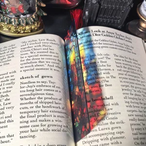 Transparent acrylic bookmark with colorful stained glass design and tassel for reading books.