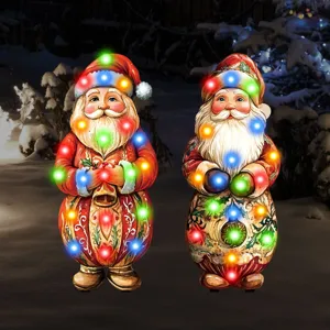Close-up detail of lighted Santa Claus garden stakes featuring colorful LED lights for yard.