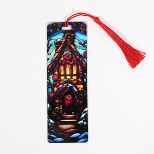 Transparent acrylic Christmas bookmark with red tassel, colorful stained glass cabin design stationery.