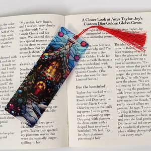 Transparent stained glass style acrylic bookmark featuring an elegant red tassel detail.