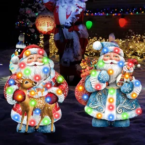 Detailed view of Christmas glowing yard stakes with Santa, reindeer and snowman decorations.