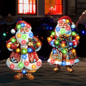 Detailed view of glowing Santa Claus garden stakes for outdoor Christmas yard decor.