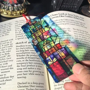 Transparent Christmas gift box acrylic bookmark detail view, elegant stained glass style stationery.