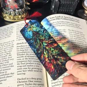 Transparent acrylic bookmark with colorful feather stained glass design, ideal for reading and stationery gifts.