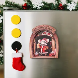 Closeup of 3D Christmas mouse hole wooden fridge magnet, festive decor on stainless steel surface.