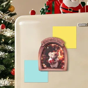 Detail shot of wooden mouse hole fridge magnet with cute holiday gift, cozy Christmas decor.