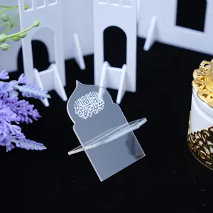 Close-up detail of a clear acrylic book stand with Arabic calligraphy for desktop decor.