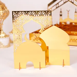 Close-up details of gold acrylic Ramadan mosque desktop ornament, ethnic architectural cutout design.