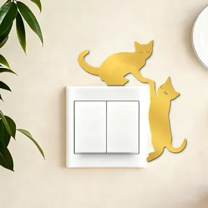 Gold acrylic mirror cat wall switch sticker, cute interactive design for home decor.