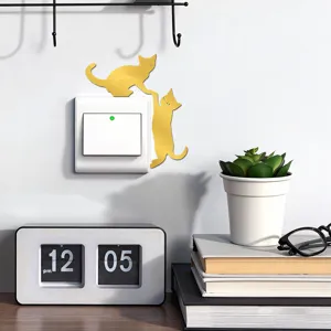 Gold acrylic cat wall switch sticker, cute interactive design, modern home decor accessory.