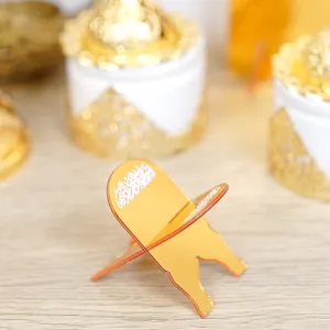 Close-up view of golden acrylic mini book stand detail, elegant desktop decorative prop.