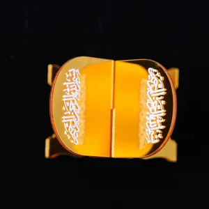 Detailed close-up view of the amber acrylic decorative book display stand with Arabic script.